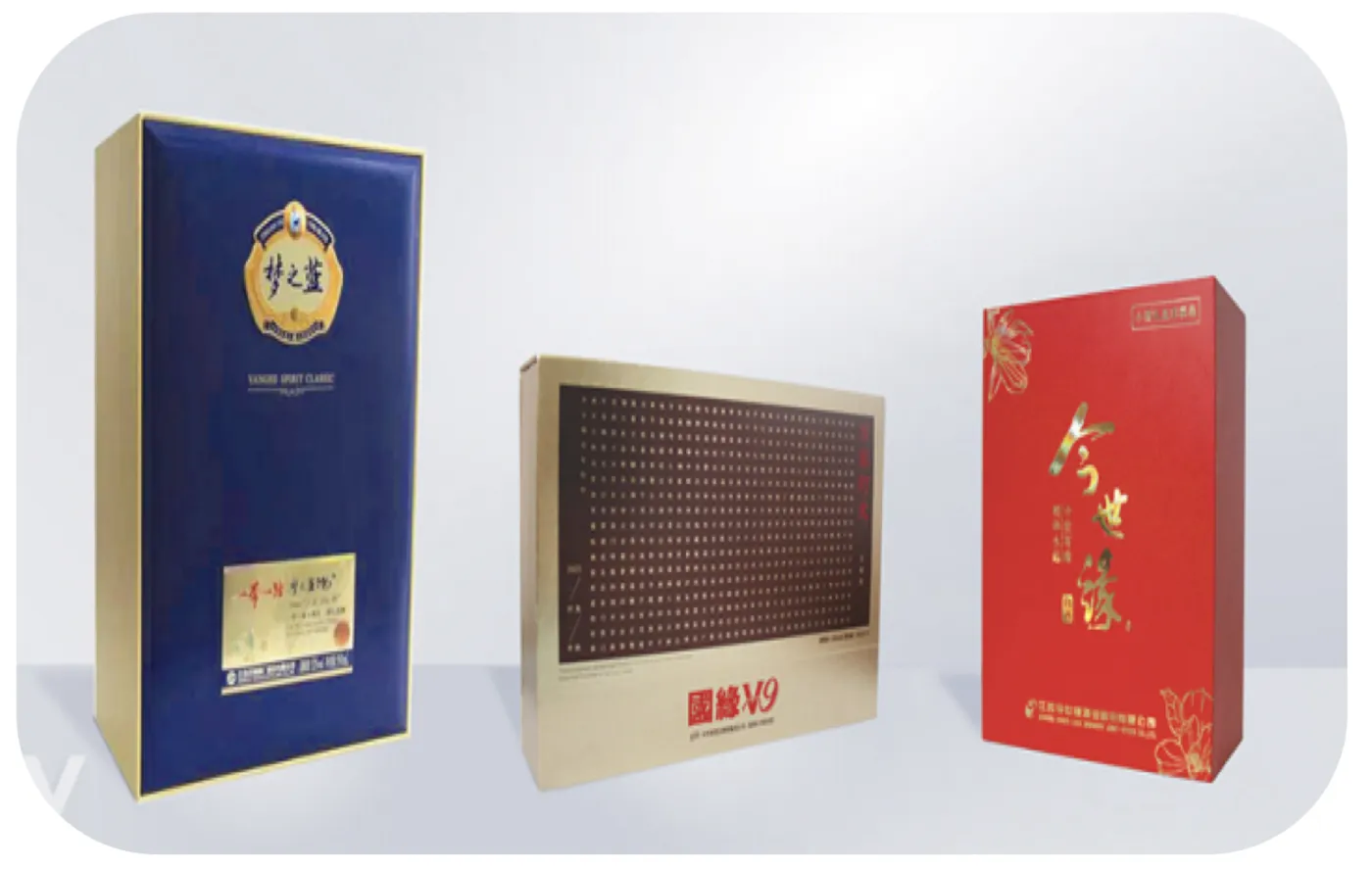 Three printed rigid gift boxes with blue, gold and red wraps