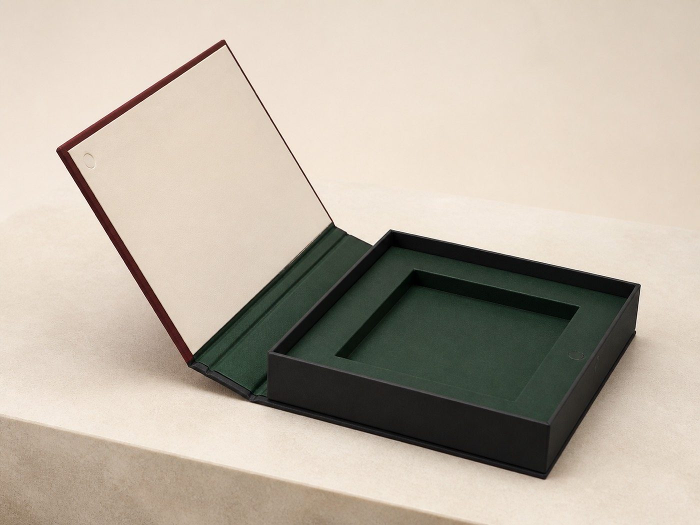 Magnetic book-style rigid box opened to show its claret cover, flexible spine and forest insert