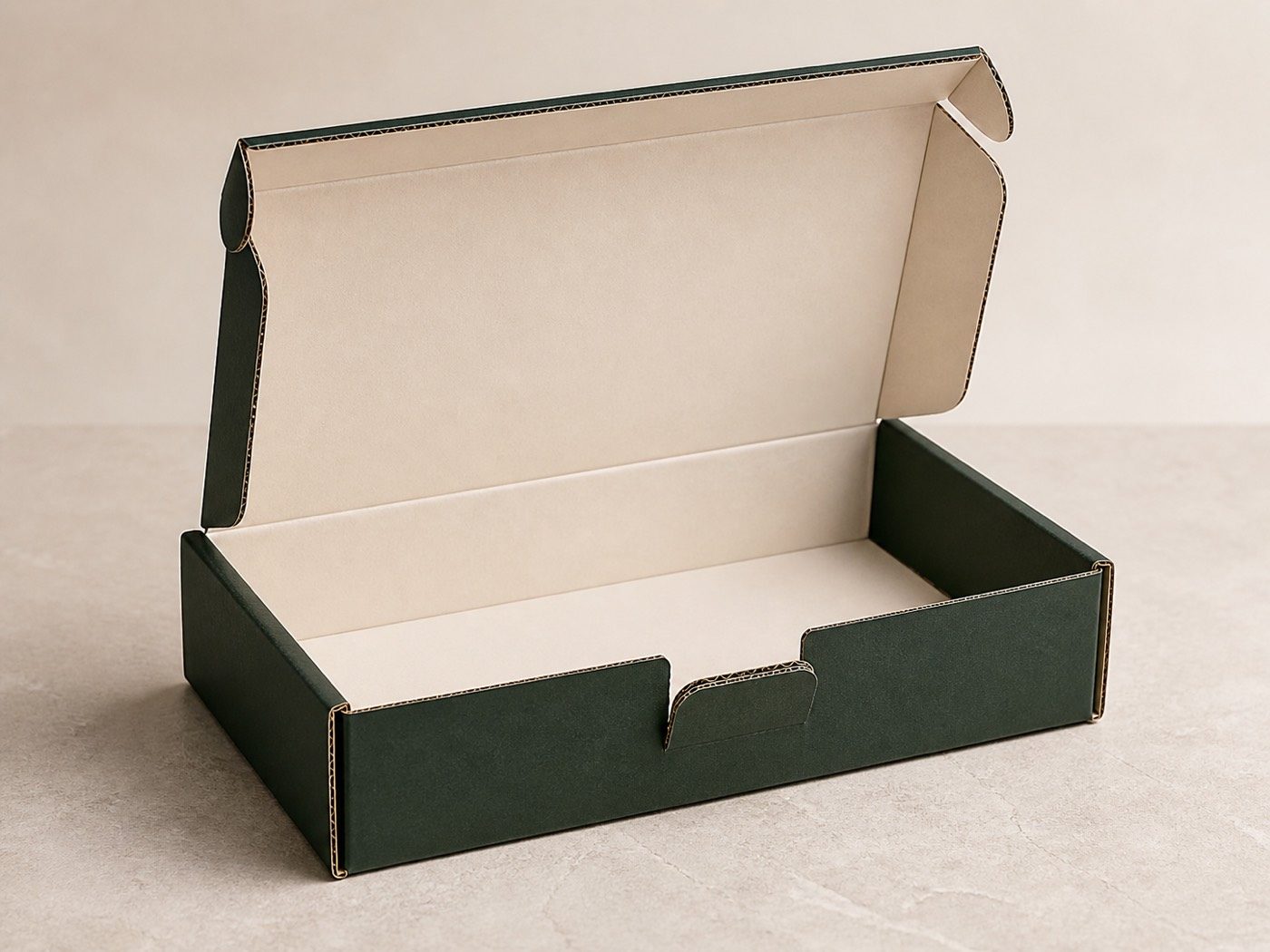 Open forest-green corrugated mailer showing its ivory liner, locking tabs and exposed flute