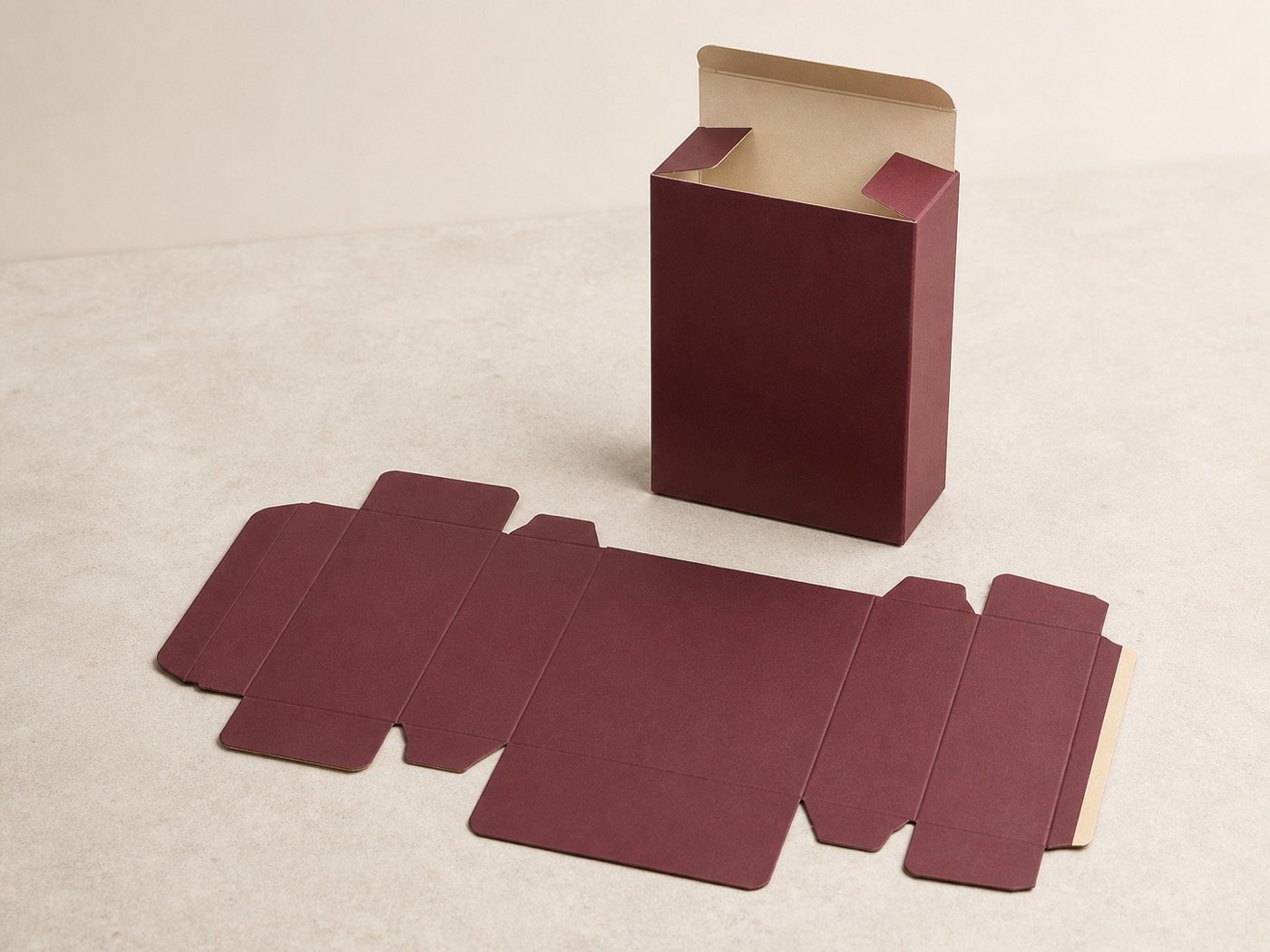 Flat claret folding-carton blank beside the same carton erected with its top flaps open